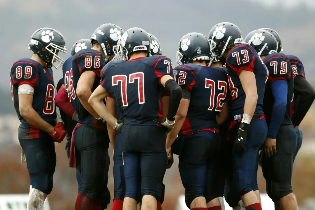 Red and blue custom football jerseys representing professional team uniforms and strong team identity through coordinated clothing.
