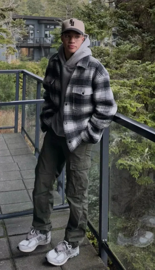 a man wearing Flannel Shirt with Jeans and Hiking Pants