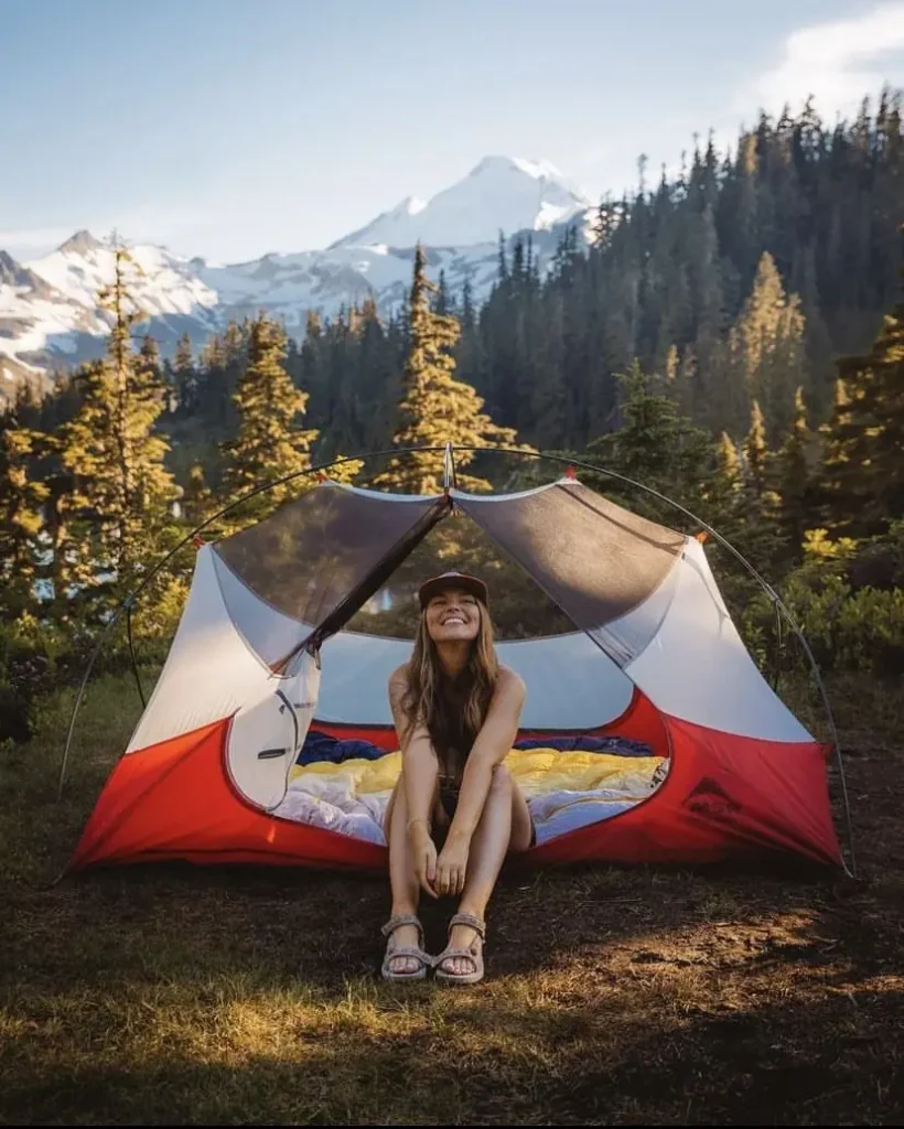 a girl in camping outfit sitting in camp