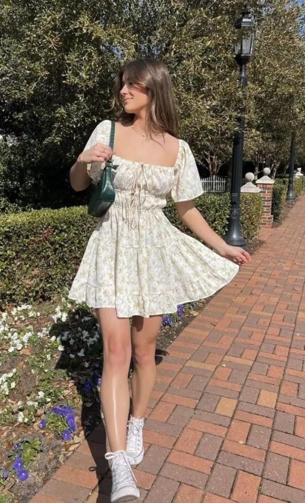 a girl wearing white short frok