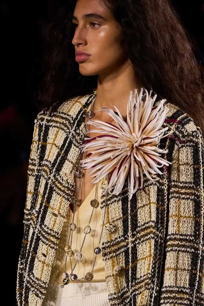 a model wearing branded brooch