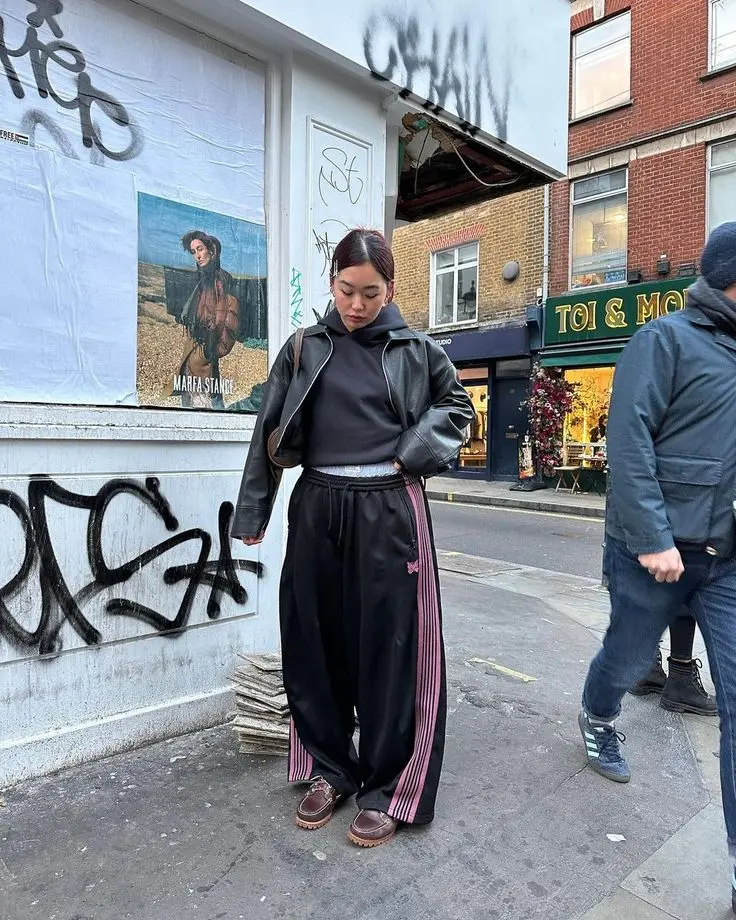 a women wearing needles pants and shrt