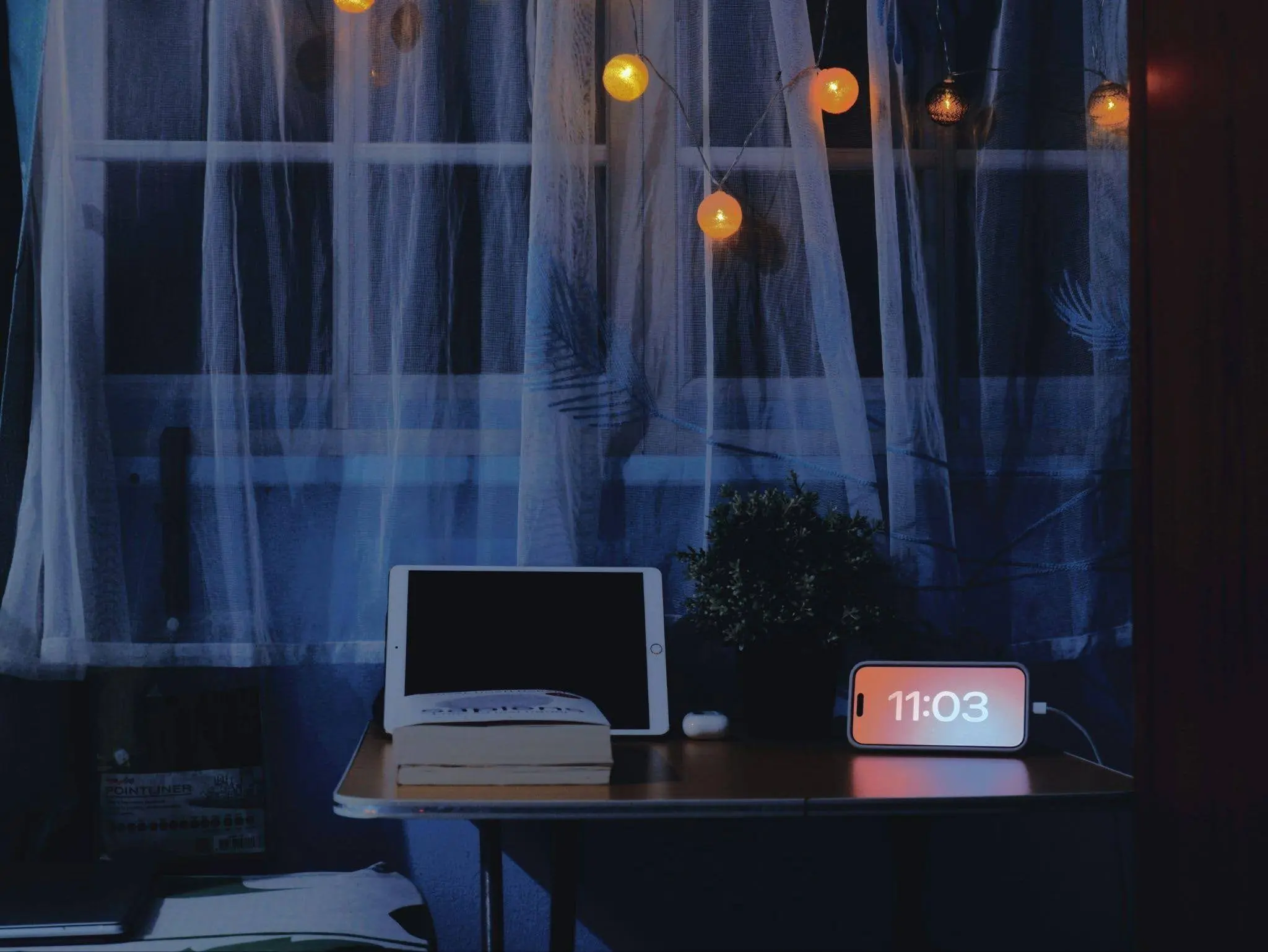 Woman relaxing in a softly lit modern living room during a peaceful nighttime routine with warm lighting and cozy home decor