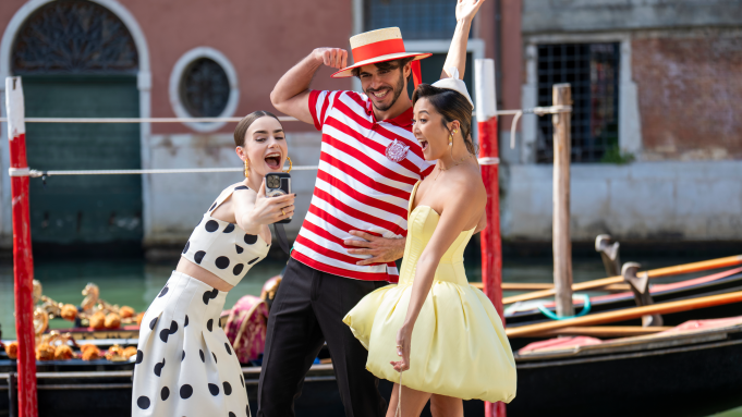 Emily in Paris cast taking a photo 3 peoples