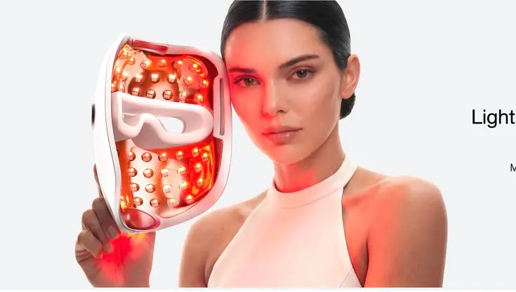 a woman with red LED face mask