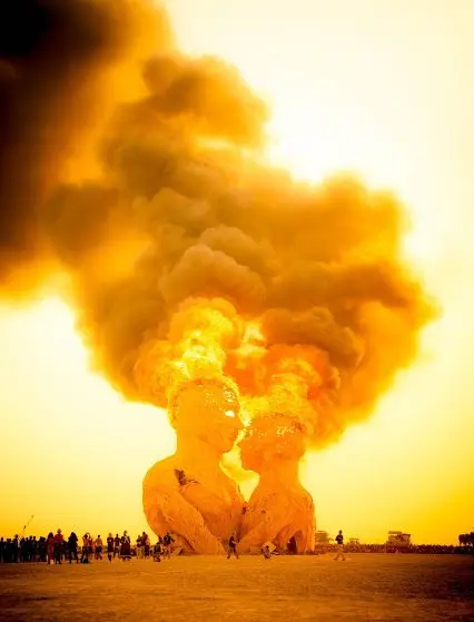 2 sculptures are being displayed in a burning man festival