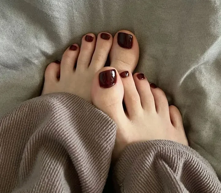 Burgundy nail paint on toe nails