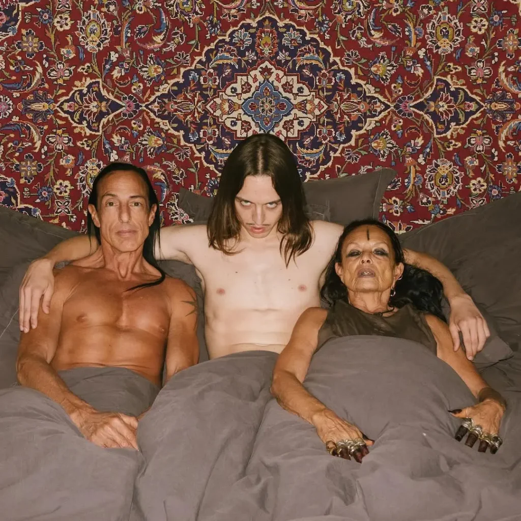 Tommy Cash with rick owen and his wife in a bed