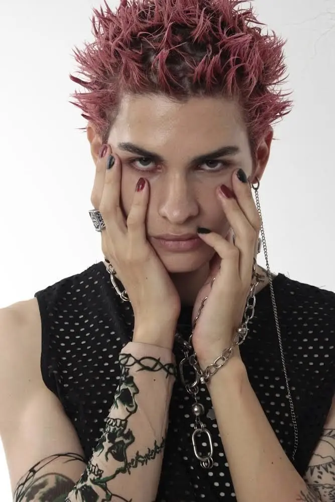 a man showing pink dyed punk hairstyle
