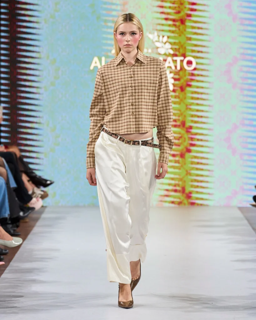 a female model on runway presenting Amato Moda collection look