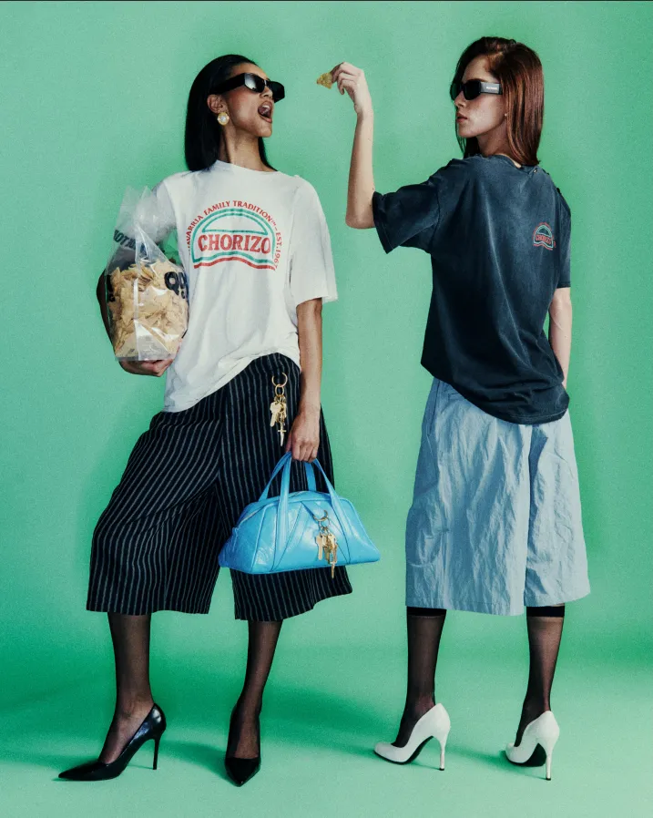 2 female posing with Willy Chavarria fashion collection dresses